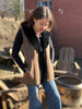Woman standing in the maven vest